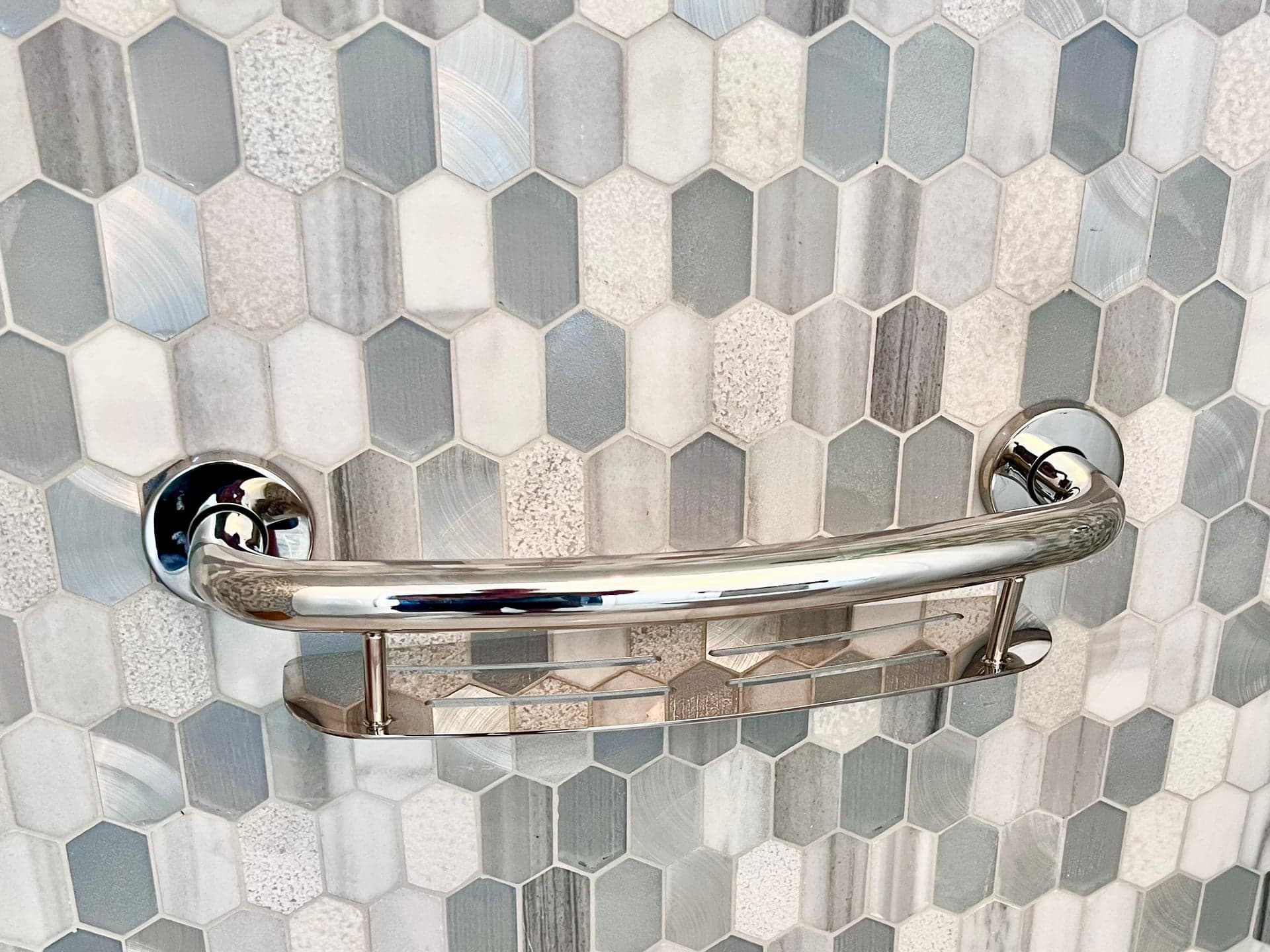 Chrome grab bar and shelf on glass hex mosaic tile