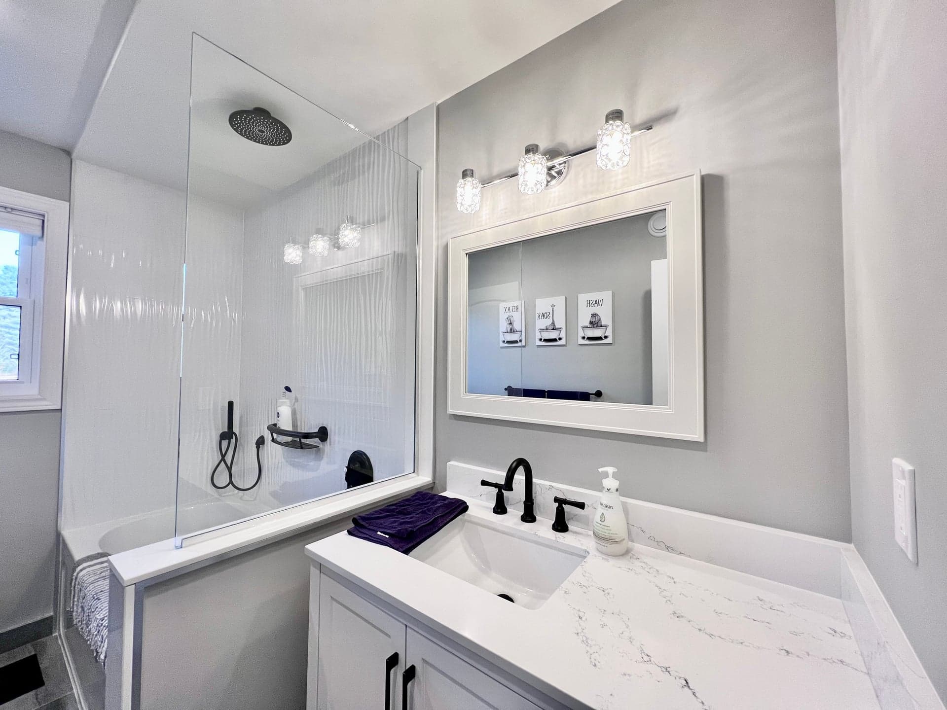 Modern bathroom with glass-panel walk-in shower and vanity